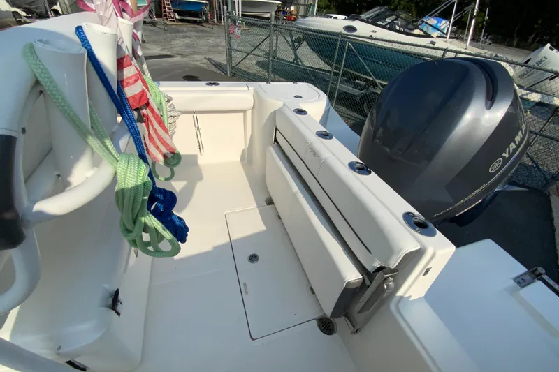 Slide: The Image of 2015 Tidewater 230 CC Adventure boat interior with Yamaha engine and colorful ropes. - 16