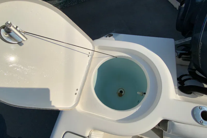 Slide: The Image of Open hatch on 2015 Tidewater 230 CC Adventure boat, revealing storage compartment. - 18