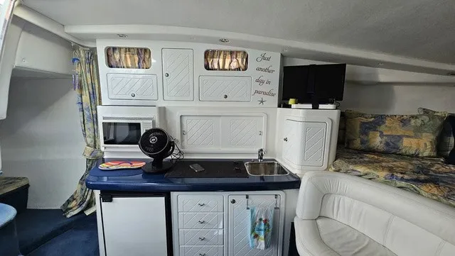 Slide: The Image of Interior of a 2001 Mustang 3200 Sport Cruiser with kitchenette, sofa, and TV. - 17