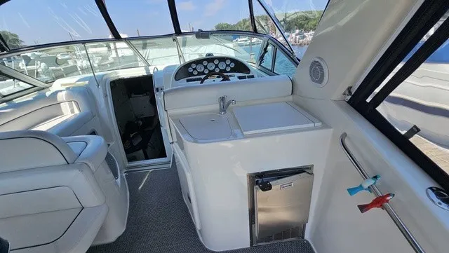 Slide: The Image of Interior of a 2001 Mustang 3200 Sport Cruiser featuring helm and seating area. - 8