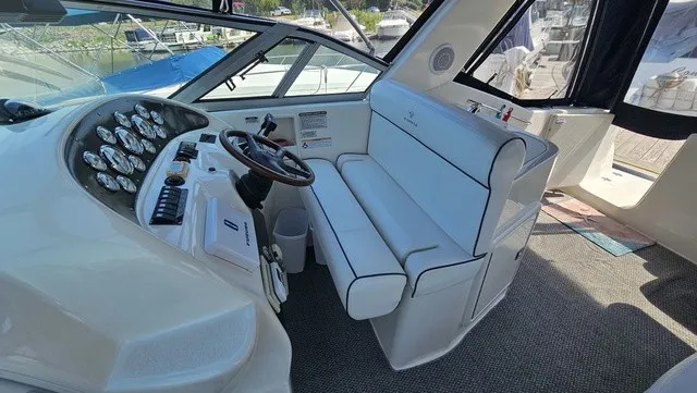 Slide: The Image of The image shows the cockpit of a 2001 Mustang 3200 Sport Cruiser with white seating and dashboard. - 10