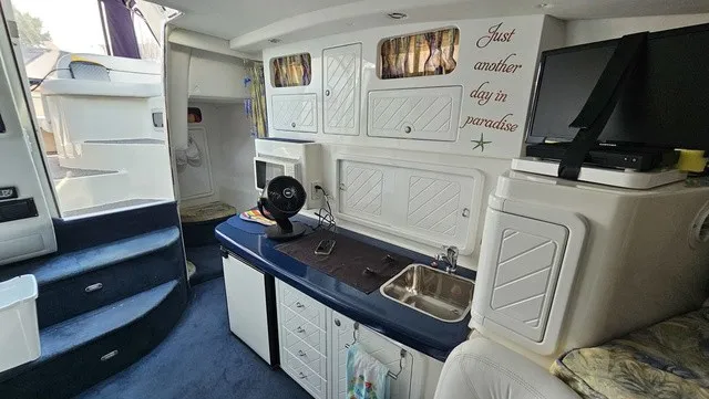 Slide: The Image of Interior of a 2001 Mustang 3200 Sport Cruiser with kitchenette and TV. - 18