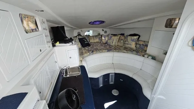 Slide: The Image of Interior of a 2001 Mustang 3200 Sport Cruiser with white leather seating and a small kitchenette. - 14
