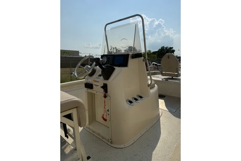 Slide: The Image of 2013 Xpress H20B Bay boat console with steering wheel and controls, outdoor setting. - 12