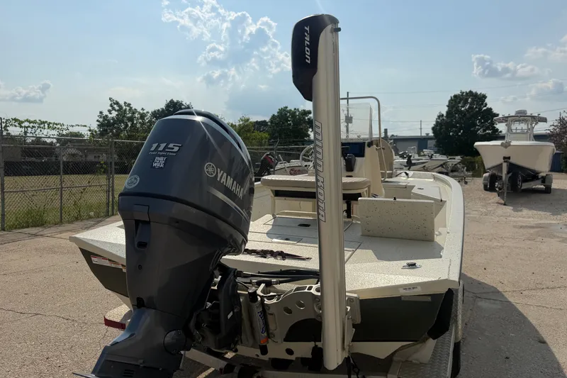 Slide: The Image of 2013 Xpress H20B Bay boat with Yamaha 115 engine, parked outdoors. - 14