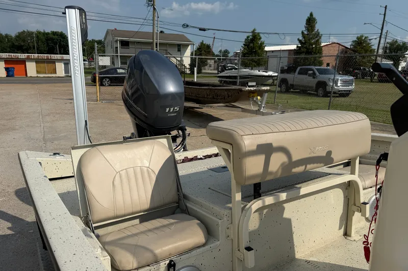 Slide: The Image of 2013 Xpress H20B Bay boat with Yamaha 115 engine, beige seating, and Minn Kota trolling motor. - 11