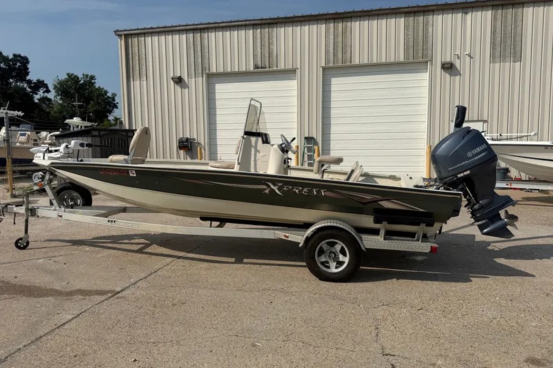 Slide: The Image of 2013 Xpress H20B Bay boat on trailer with Yamaha outboard motor. - 2