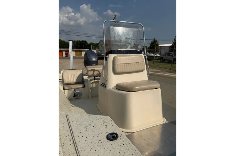 Slide: The Image of 2013 Xpress H20B Bay boat with beige seating and console, parked outdoors. - 10