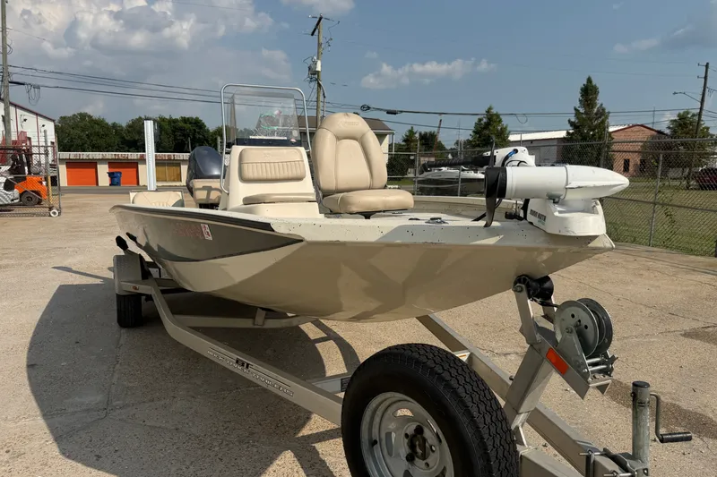 Slide: The Image of 2013 Xpress H20B Bay boat on trailer, parked outdoors under a clear sky. - 8