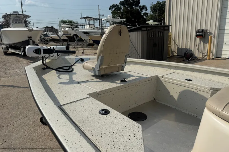 Slide: The Image of 2013 Xpress H20B Bay boat with seating and trolling motor in a marina setting. - 17