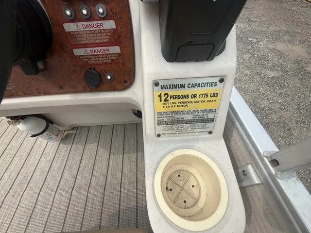 Slide: The Image of Close-up of a boat console area with capacity label for 12 persons or 1775 pounds. - 10