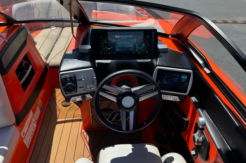 Slide: The Image of 2018 Malibu Wakesetter 22 MXZ boat dashboard with modern controls and touchscreen displays. - 29