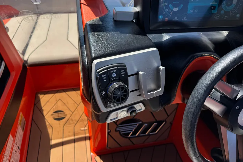 Slide: The Image of 2018 Malibu Wakesetter 22 MXZ dashboard with control panel and steering wheel. - 30