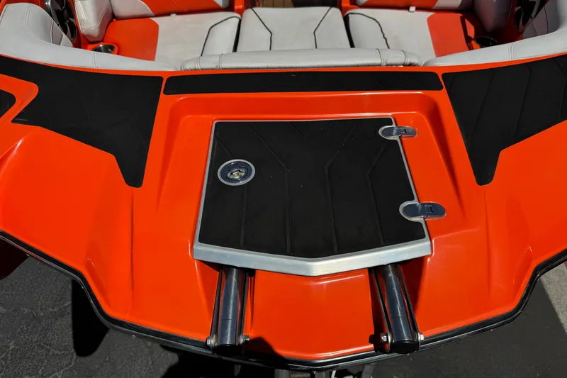 Slide: The Image of 2018 Malibu Wakesetter 22 MXZ boat with orange and black deck design. - 10