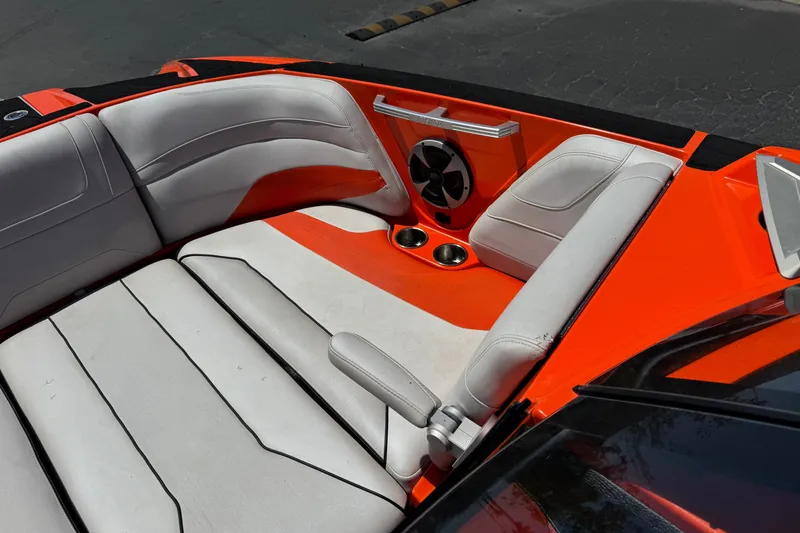 Slide: The Image of Interior of 2018 Malibu Wakesetter 22 MXZ boat with orange and white seating. - 15