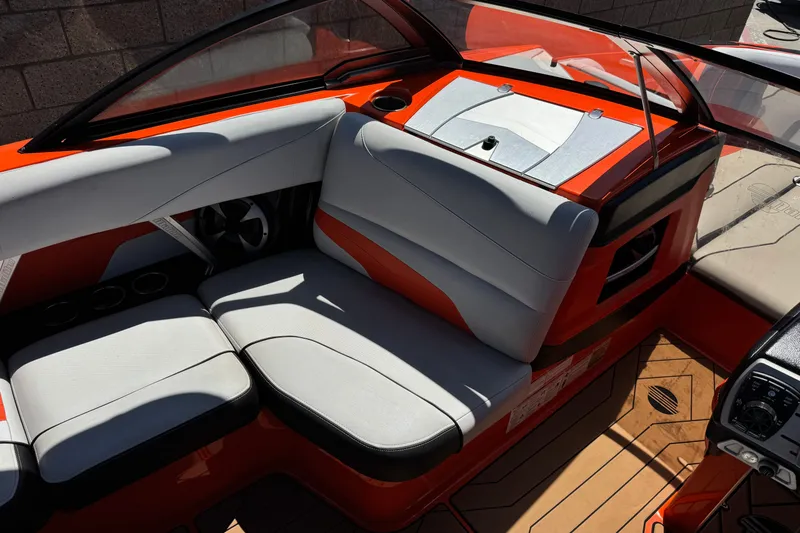Slide: The Image of 2018 Malibu Wakesetter 22 MXZ interior with orange and gray seating, sleek design. - 25