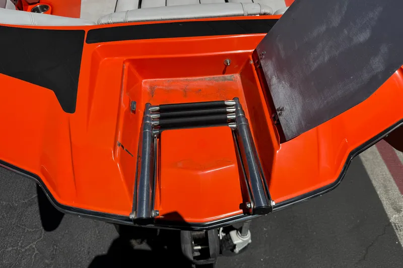 Slide: The Image of 2018 Malibu Wakesetter 22 MXZ swim platform with foldable ladder, vibrant orange finish. - 11