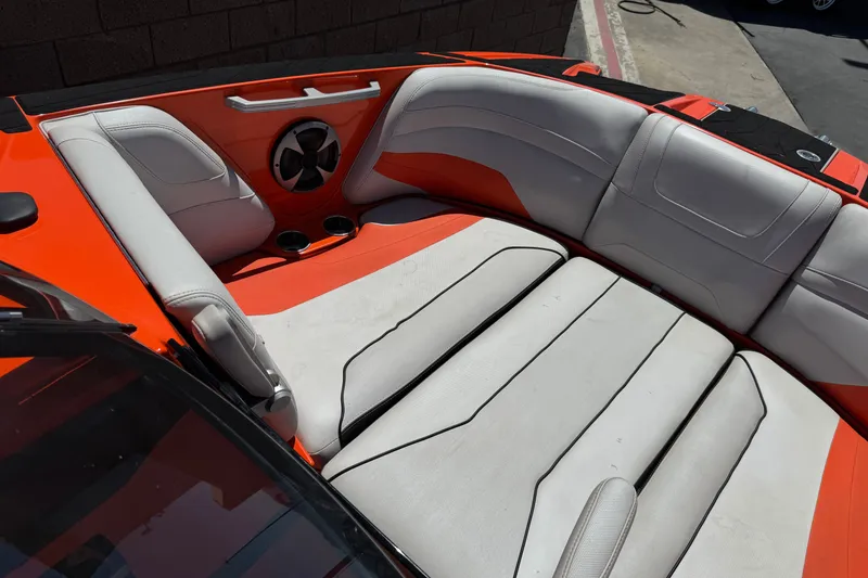 Slide: The Image of Interior of 2018 Malibu Wakesetter 22 MXZ boat with orange and white seating. - 14