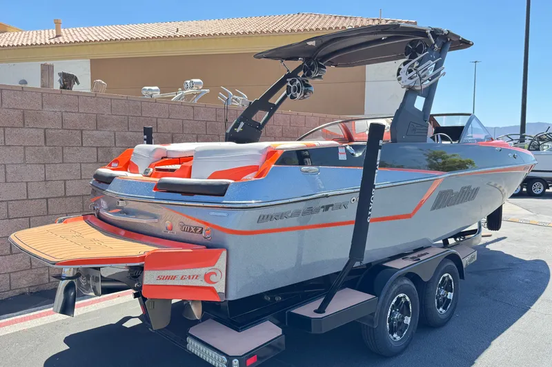 Slide: The Image of 2018 Malibu Wakesetter 22 MXZ boat on trailer, featuring sleek design and vibrant accents. - 5