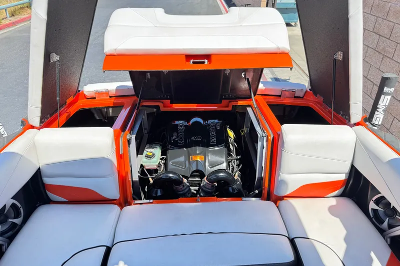 Slide: The Image of 2018 Malibu Wakesetter 22 MXZ boat engine compartment with open hatches and seating. - 21