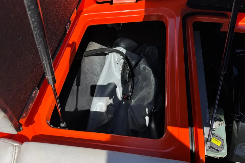 Slide: The Image of 2018 Malibu Wakesetter 22 MXZ storage compartment with ballast bag and hydraulic struts. - 24