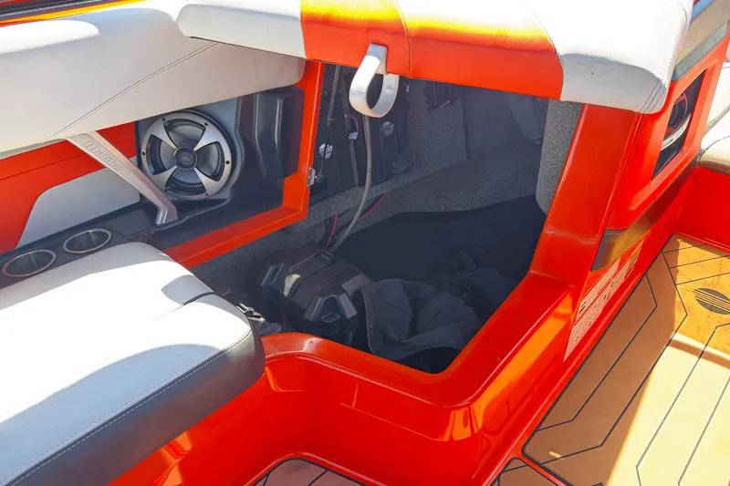Slide: The Image of 2018 Malibu Wakesetter 22 MXZ interior with orange accents and speaker system. - 26