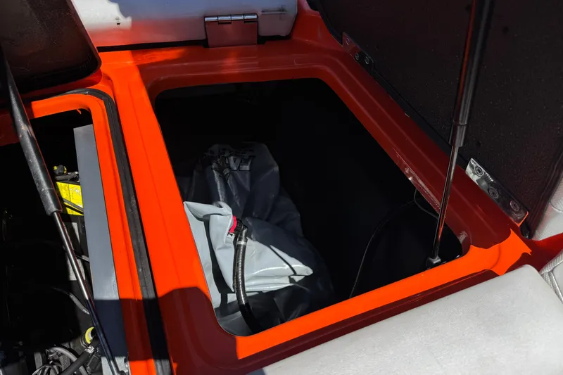 Slide: The Image of Open storage compartment in 2018 Malibu Wakesetter 22 MXZ boat. - 23
