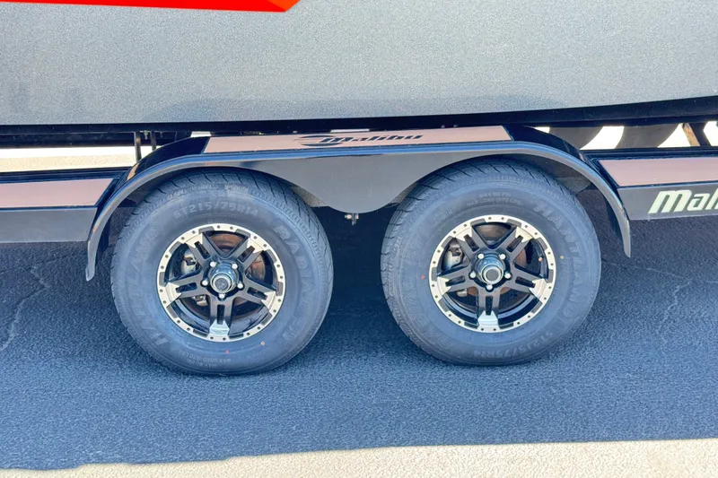 Slide: The Image of 2018 Malibu Wakesetter 22 MXZ trailer wheels on asphalt surface. - 34