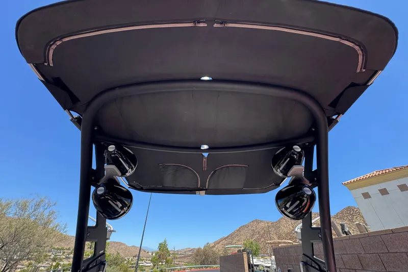Slide: The Image of 2018 Malibu Wakesetter 22 MXZ boat tower with speakers, under clear blue sky. - 16