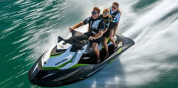 Slide: The Image of Three people ride a Sea-Doo GTI SE 130 jet ski across the water. - 5