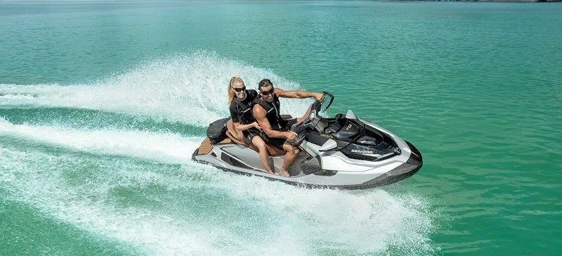 Slide: The Image of A couple rides a Sea-Doo GTX Limited 300 jet ski across turquoise water. - 8