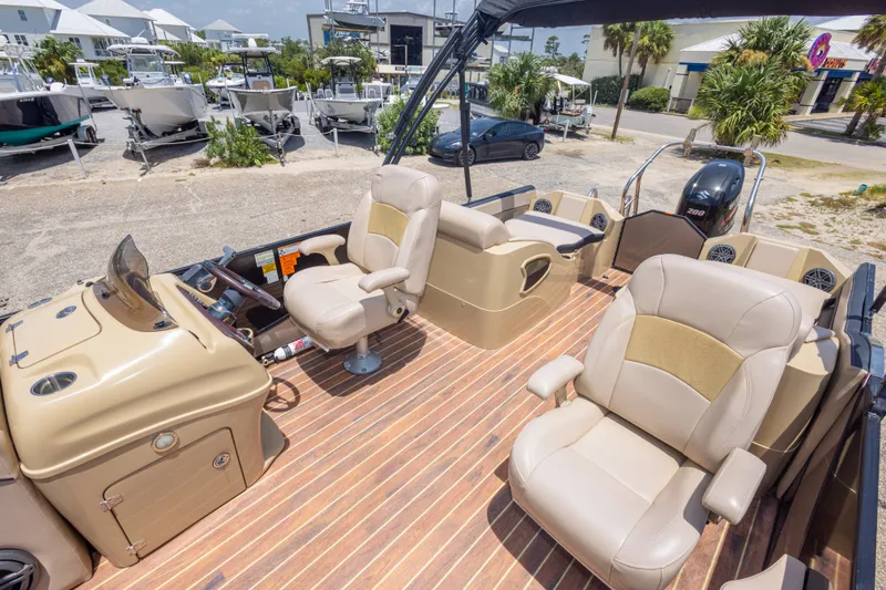 Slide: The Image of 2017 South Bay 523SL pontoon boat interior with beige seating and wood-style flooring. - 30