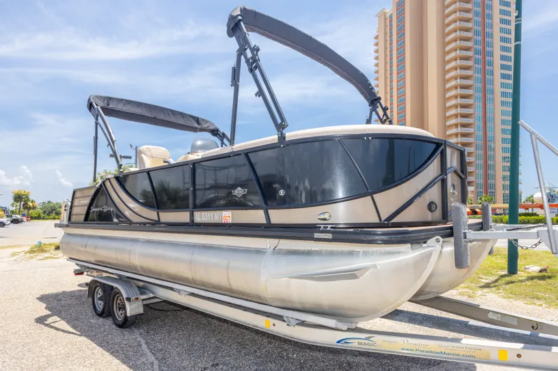 Slide: The Image of 2017 South Bay 523SL pontoon boat on trailer, parked near tall building. - 9
