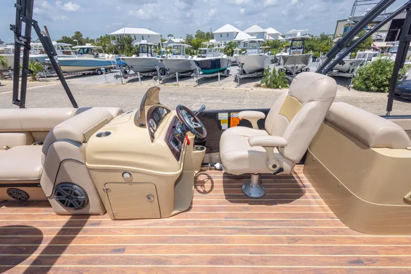 Slide: The Image of 2017 South Bay 523SL boat interior with beige seating and control panel, docked at marina. - 36