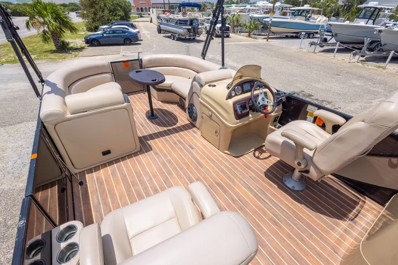 Slide: The Image of Luxurious 2017 South Bay 523SL pontoon boat interior with plush seating and sleek dashboard. - 24