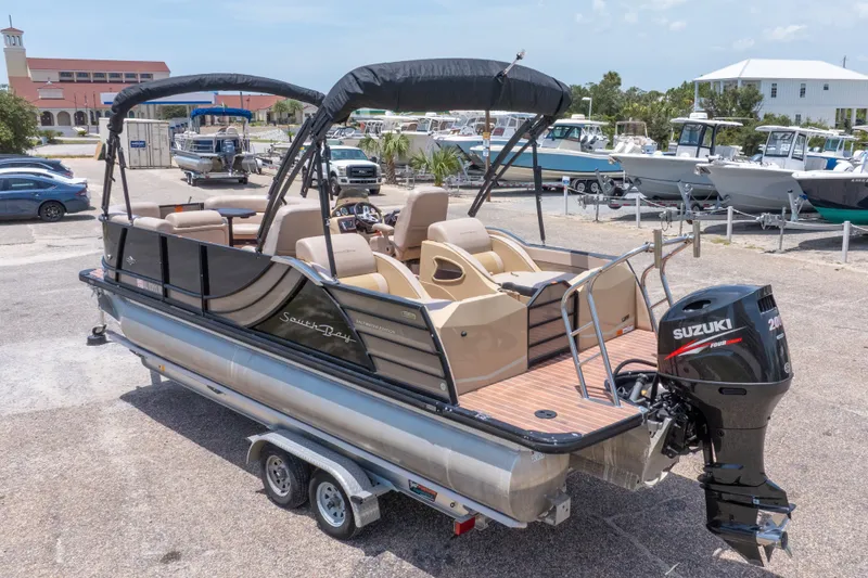 Slide: The Image of 2017 South Bay 523SL pontoon boat with Suzuki outboard motor, parked on a trailer. - 45