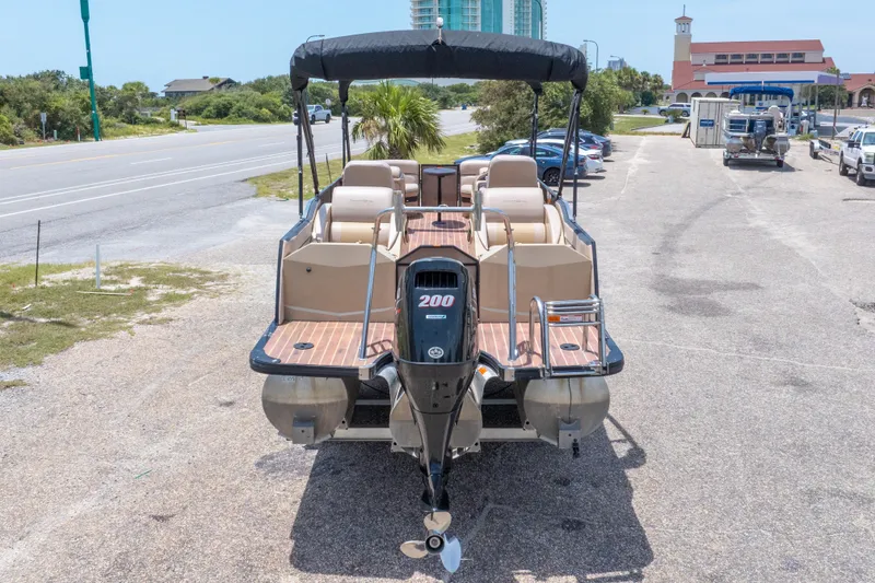 Slide: The Image of 2017 South Bay 523SL pontoon boat with 200 HP engine, parked near a road. - 44
