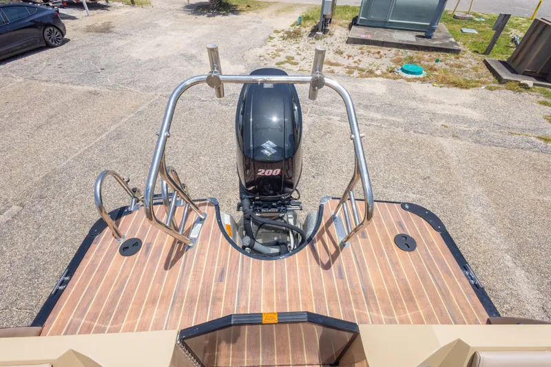 Slide: The Image of 2017 South Bay 523SL boat with a 200 HP outboard motor on a wooden deck. - 39