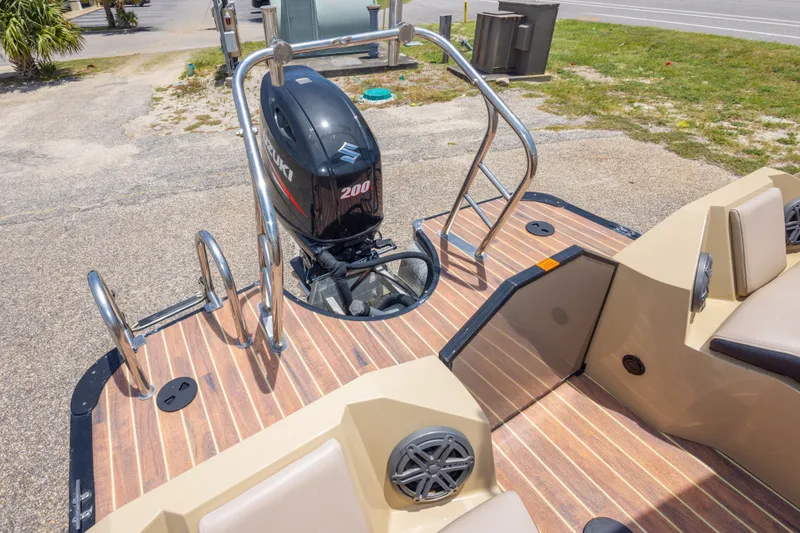 Slide: The Image of 2017 South Bay 523SL boat with Suzuki 200 outboard motor and wooden deck. - 37