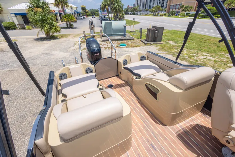 Slide: The Image of 2017 South Bay 523SL pontoon boat interior with beige seating and wood-style flooring. - 31