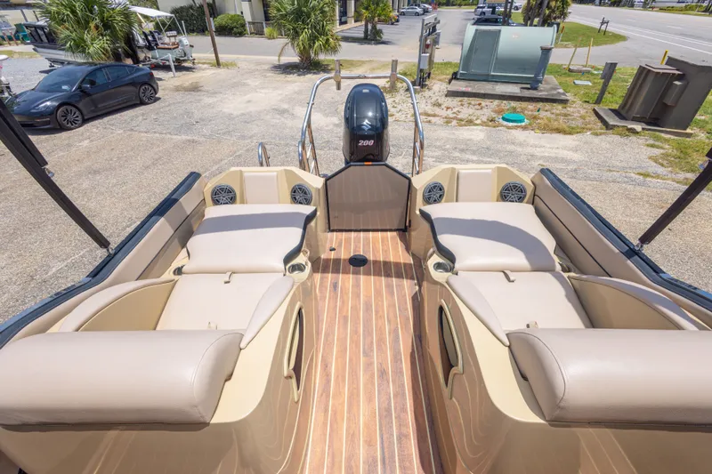 Slide: The Image of 2017 South Bay 523SL pontoon boat interior with plush seating and wood-style flooring. - 32