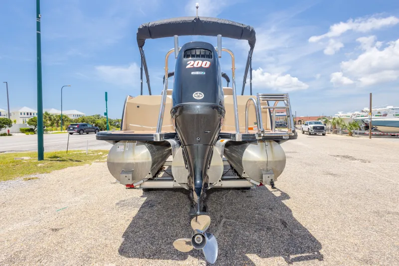 Slide: The Image of 2017 South Bay 523SL pontoon boat with powerful outboard motor, parked on sunny day. - 14
