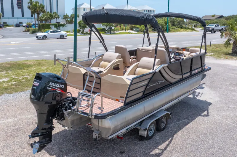 Slide: The Image of 2017 South Bay 523SL pontoon boat with Suzuki engine on trailer, parked near road. - 43