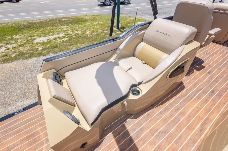 Slide: The Image of Luxurious seating on 2017 South Bay 523SL boat with beige upholstery and cup holders. - 22