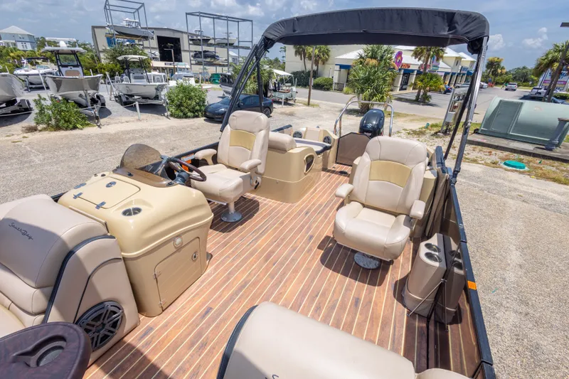 Slide: The Image of 2017 South Bay 523SL pontoon boat with beige seating and wood-style flooring. - 29