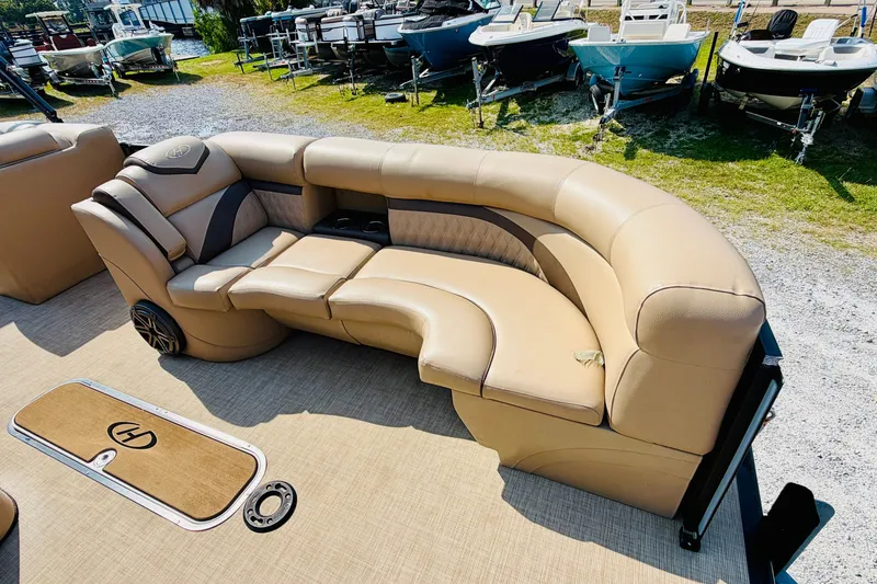 Slide: The Image of Luxurious seating on a 2019 Harris Sunliner 230 pontoon boat, surrounded by other boats. - 11
