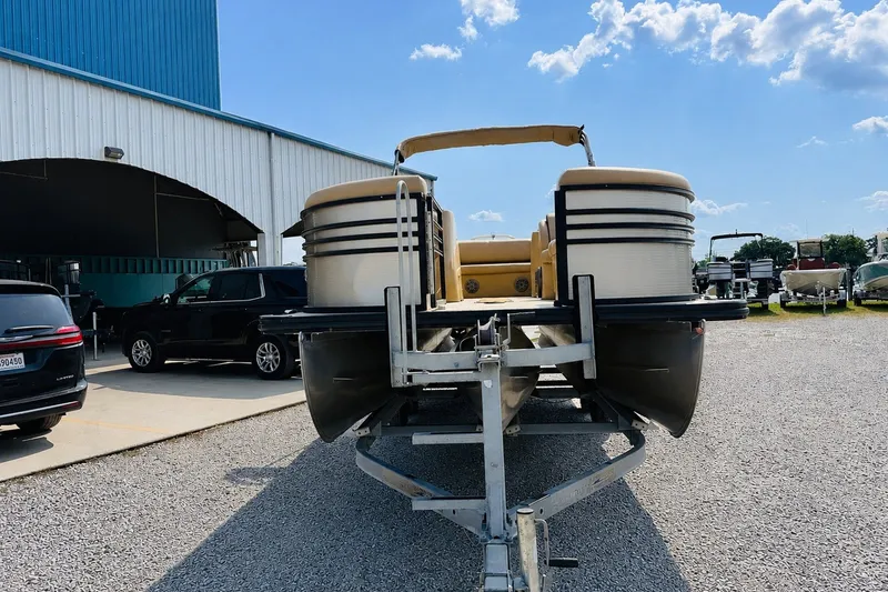 Slide: The Image of 2019 Harris Sunliner 230 pontoon boat on trailer, parked outdoors under blue sky. - 6