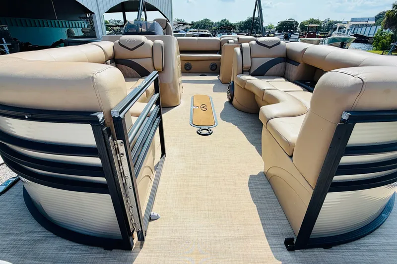Slide: The Image of 2019 Harris Sunliner 230 pontoon boat interior with beige seating and spacious layout. - 9
