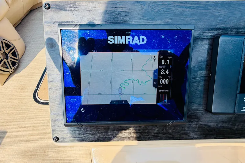 Slide: The Image of Simrad navigation display on 2019 Harris Sunliner 230 boat dashboard. - 24