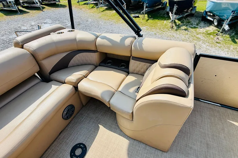 Slide: The Image of Luxurious seating on 2019 Harris Sunliner 230 pontoon boat, featuring beige upholstery and cup holders. - 15